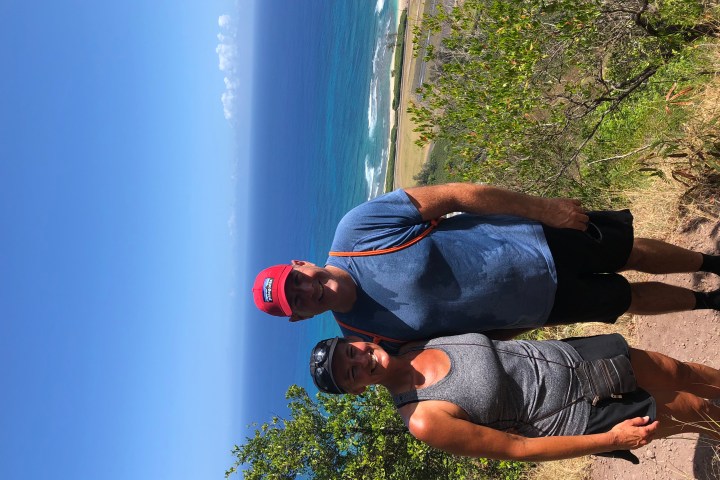 man and woman smiling on hike in oahu